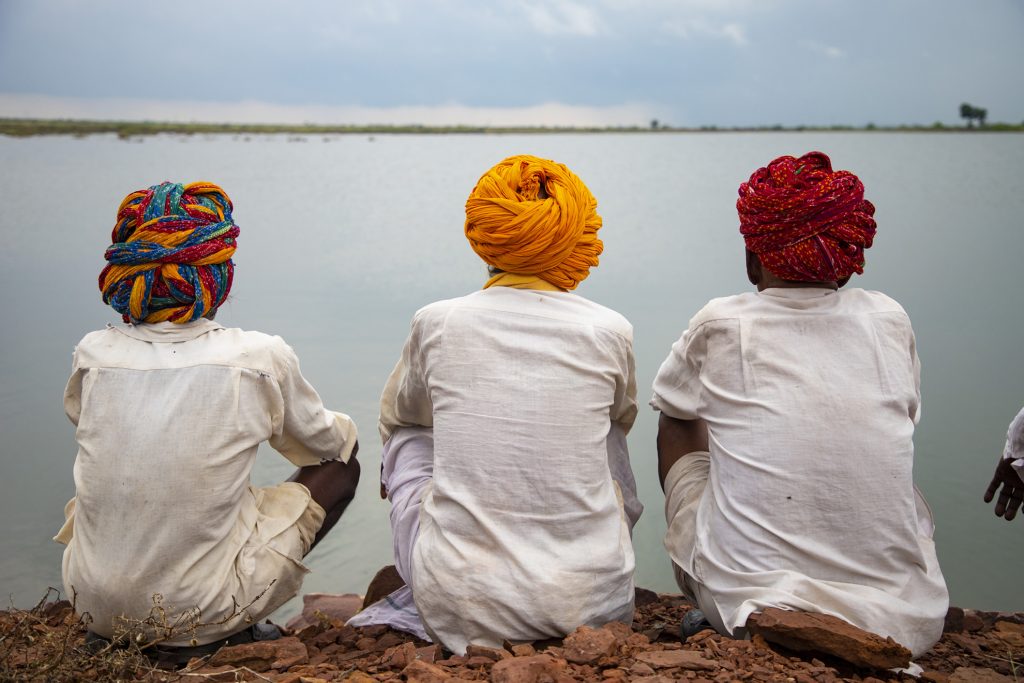 Three old man with  colorful turban on their head. sitting at bank of manmade lake for water conversation. These old man from Kota, Rajasthan, India