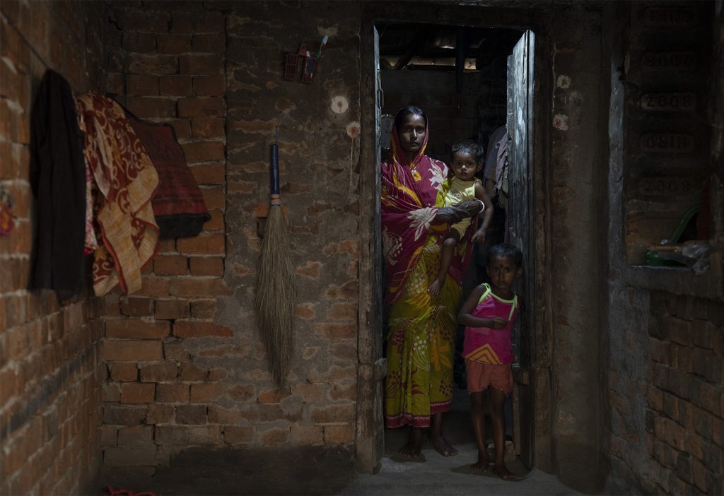 Poor VIllage woman with kid in her home, VIllage Jhirhati, Pakur, Jharkhand, India